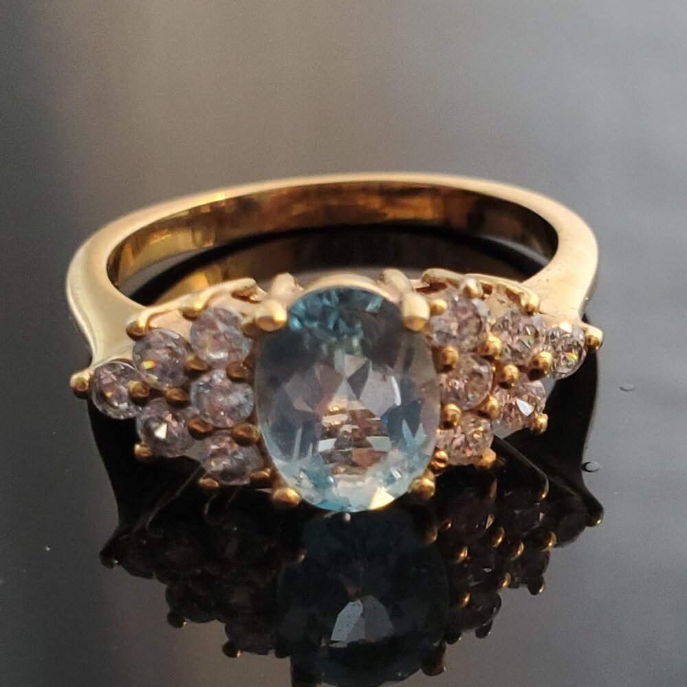 Gold ring set with pale blue gems